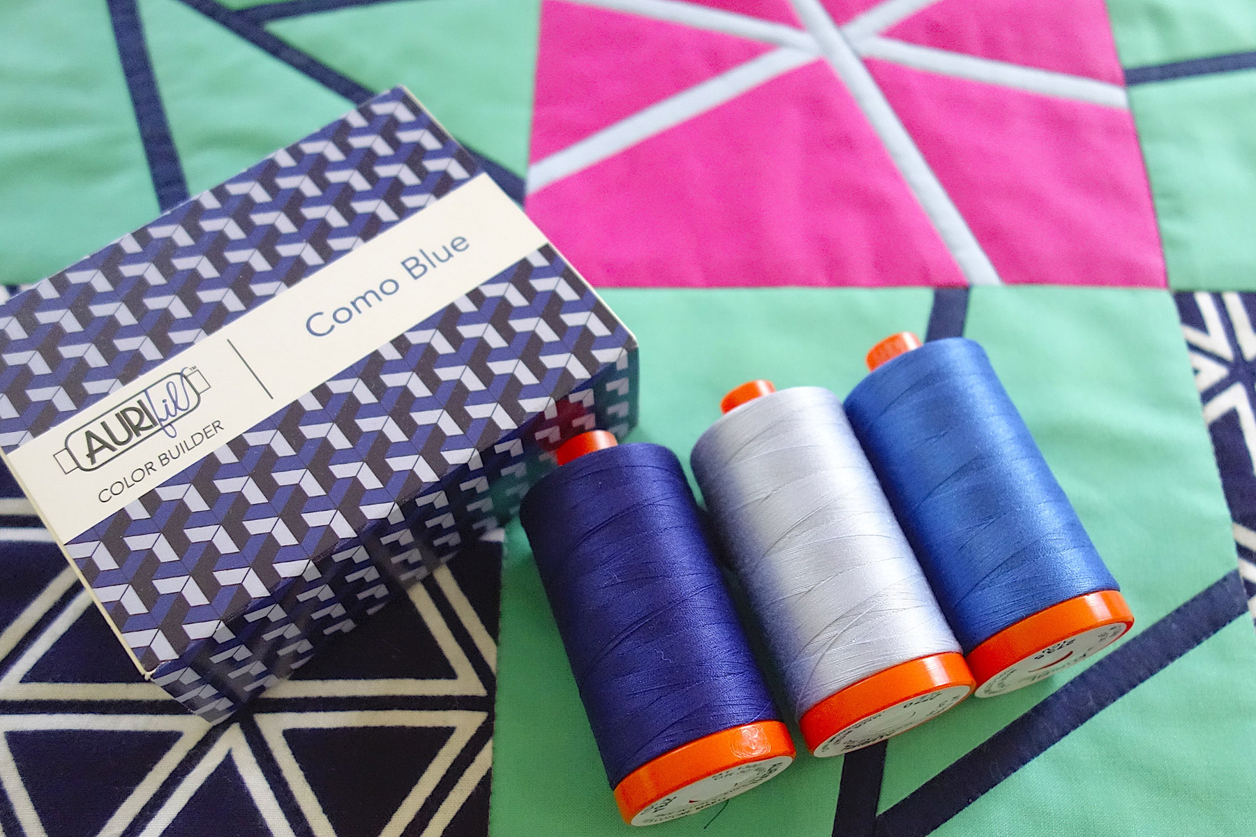 Aurifil Como Blue Color Builder Thread Set on Purity, a baby quilt by Patricia Belyea