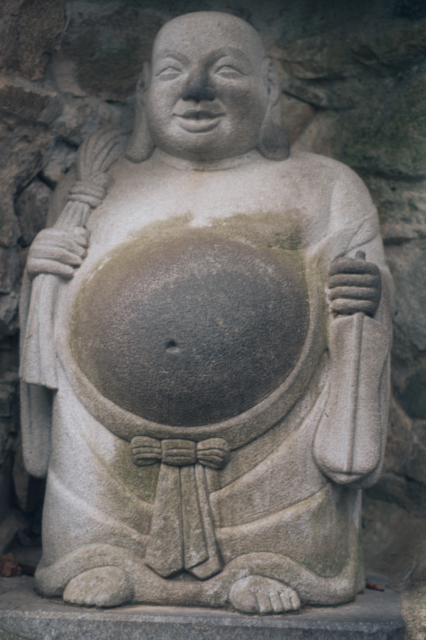 Rubbing Buddha's belly for luck