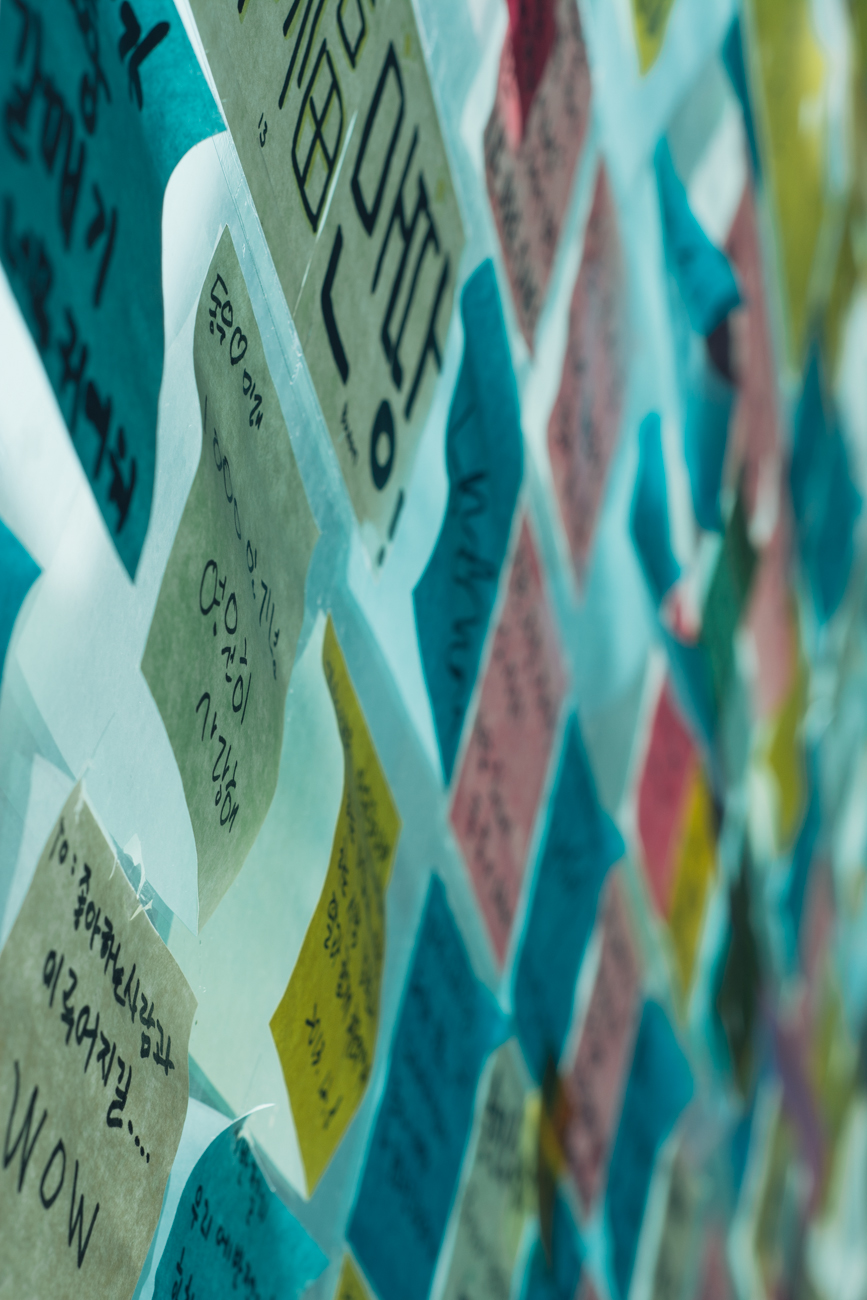 A bunch of sticky notes on the window in the hostel