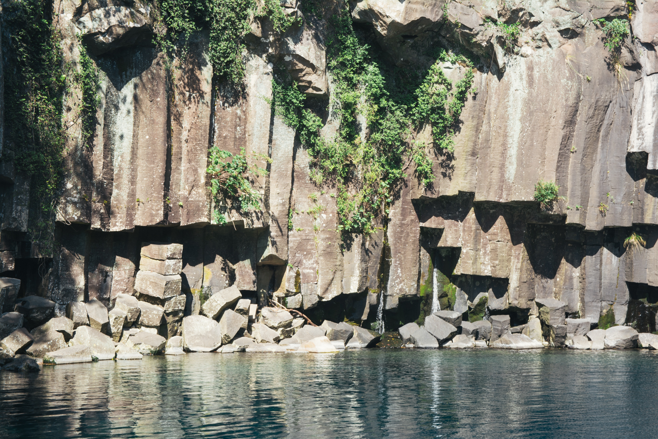 The rocks behind the waterfall