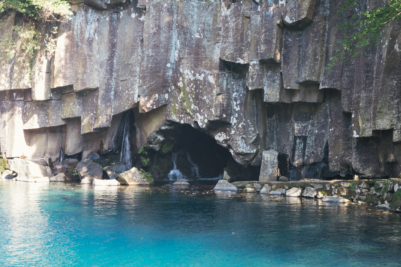 The rocks behind the waterfall