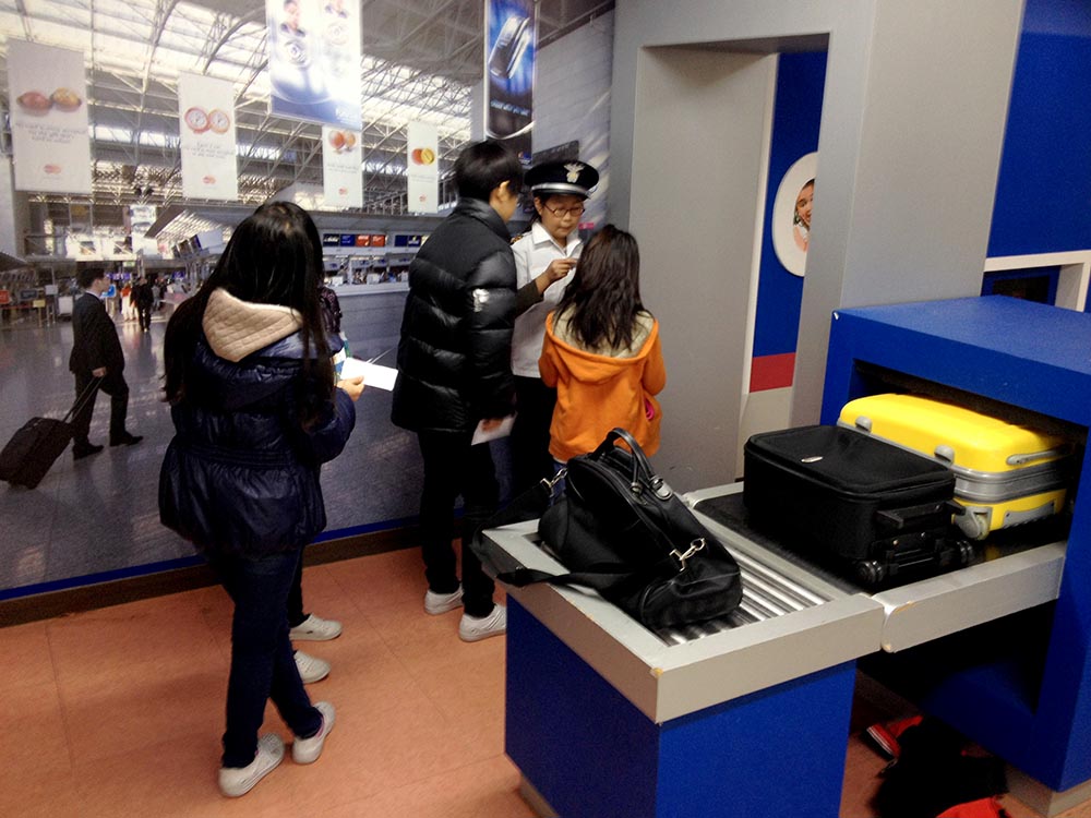 Students Role-playing as Security Guards and Passengers in the airport