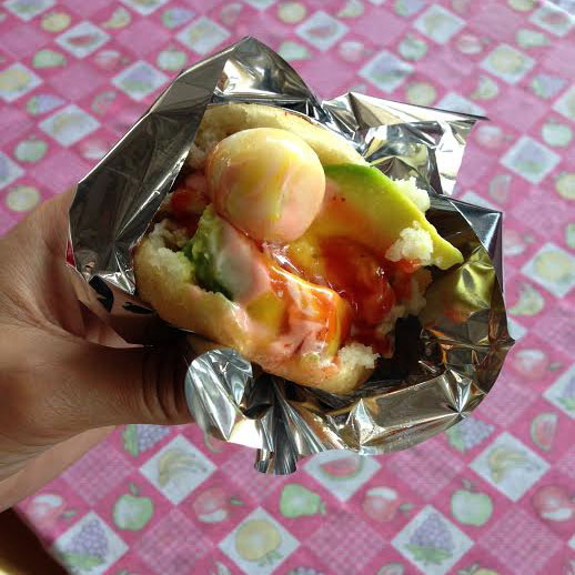 This is an example of a San Gil Arepa. It comes stuffed with chicken, avocado, a quail egg and is drizzled with two different sauces. Photo: Alex Washburn
