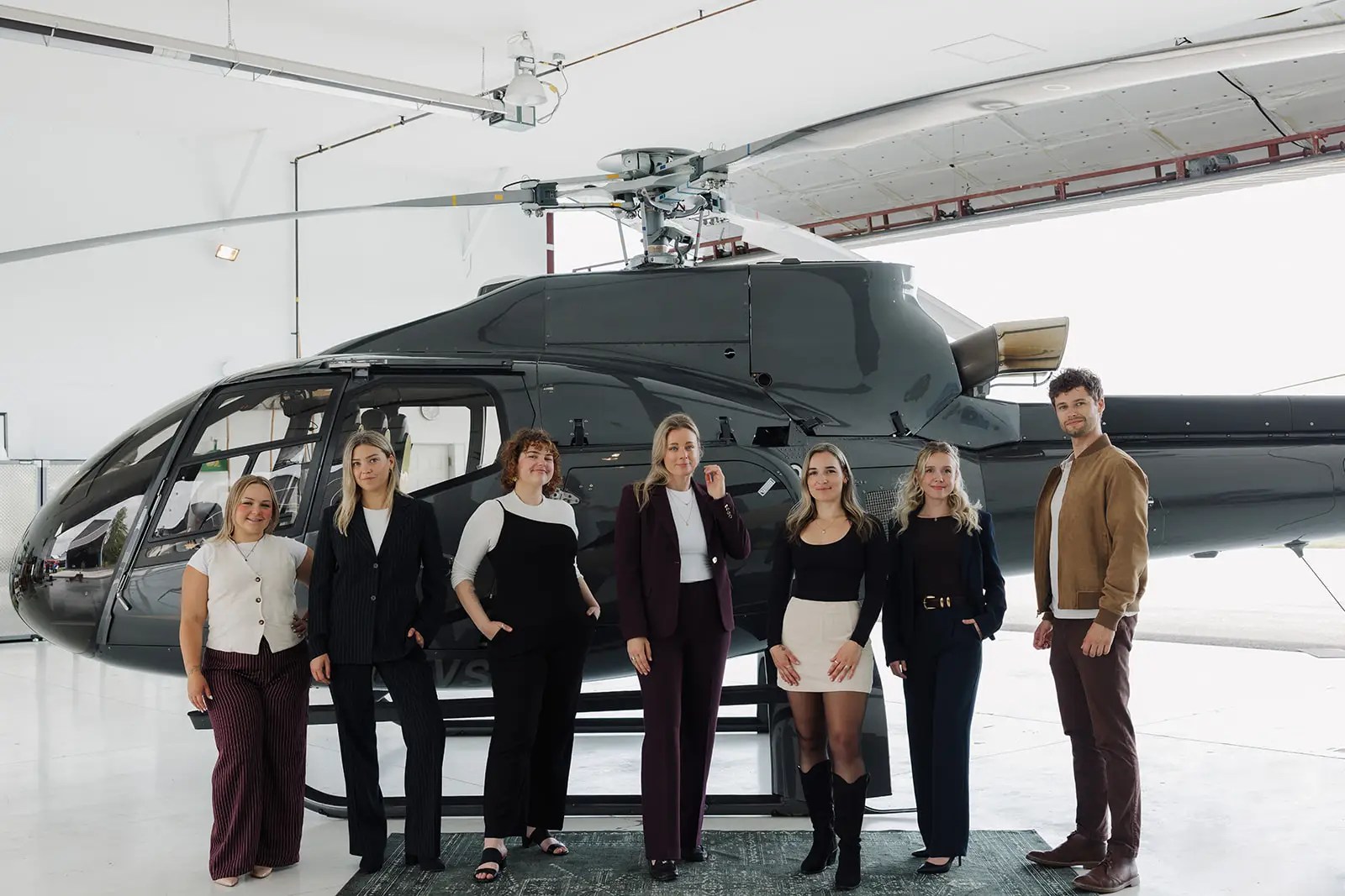aviation marketing team standing in front of helicopter