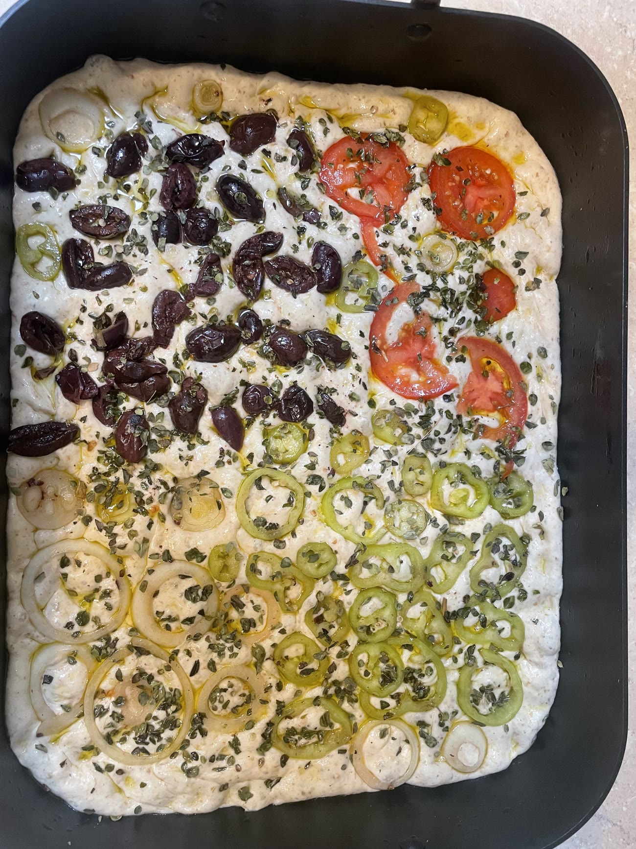 Ehsan Omara's focaccia, mixed in a wooden bowl.