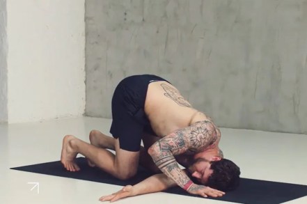 photograph of a tatooed man in thread the needle pose