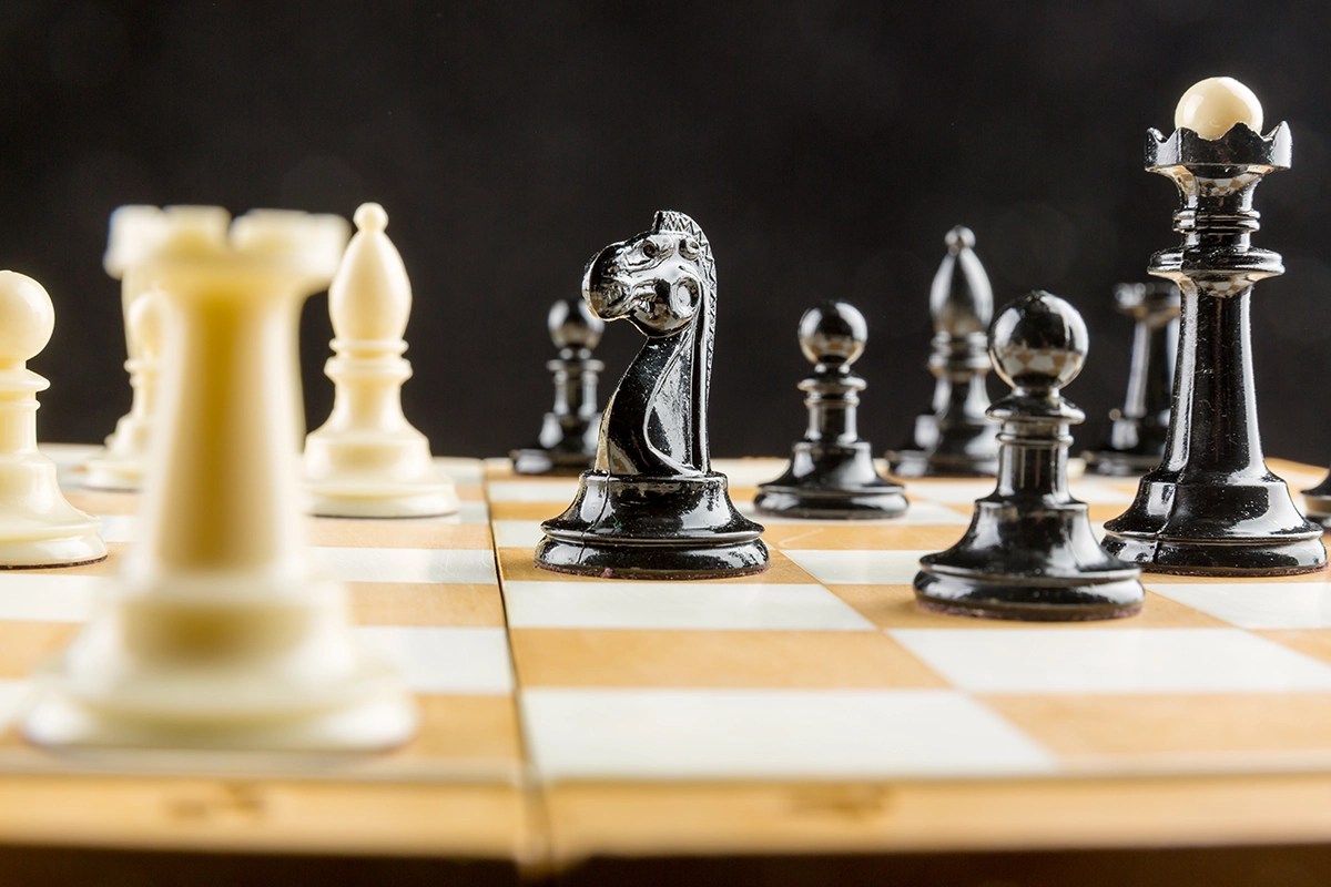 Chess pieces in strategic formation on a board, symbolizing strategic web design, smart business decisions, and rapid problem-solving.