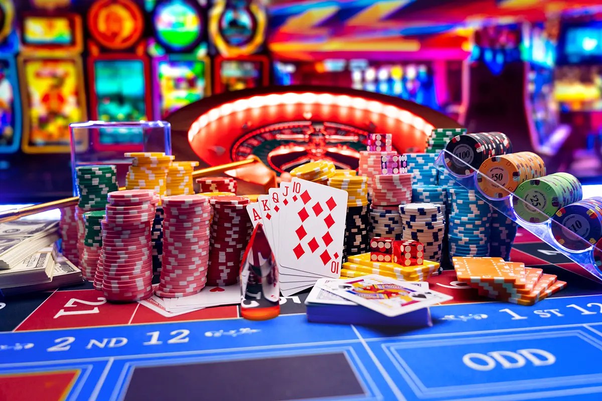 Casino table with roulette wheel, poker chips, cards, and dice representing the risky nature of flat-rate website design