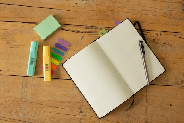 A blank notebook with a pen on top, ready to be used for writing a financial plan based on fundamental analysis.
