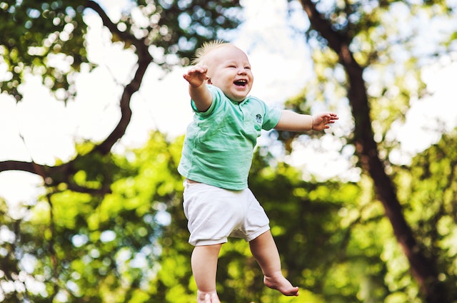 A baby is laughing and playing