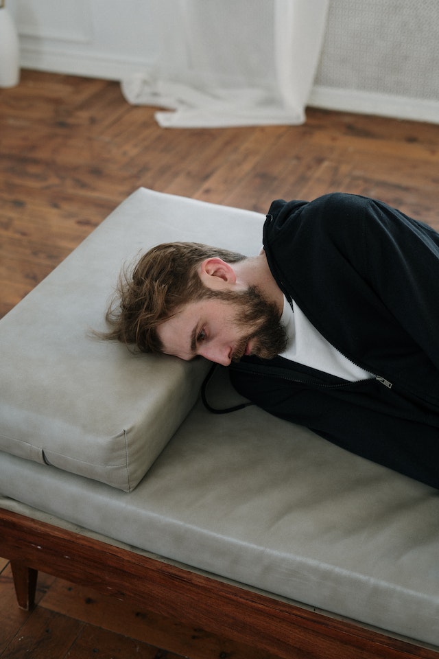An emotional trader experiencing distress and regret due to poor trades driven by emotions instead of analysis.