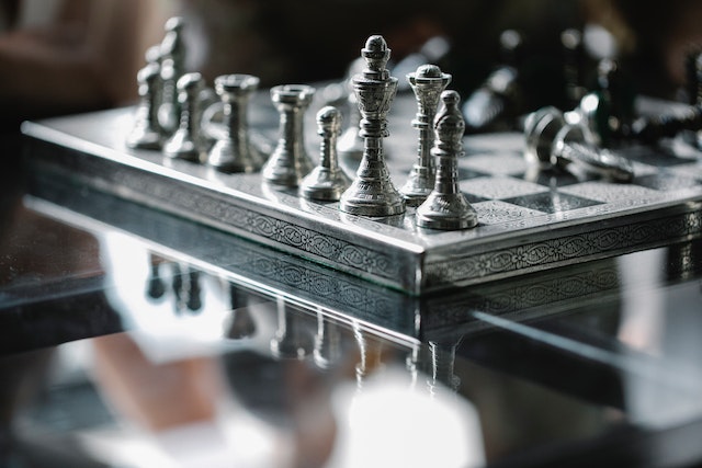 A chessboard with strategically placed chess pieces.