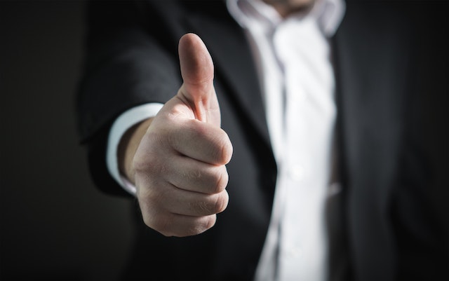 Thumbs-Up Gesture: A Symbol of Approval and Success, Illustrating Triumph in the World of Negotiation
