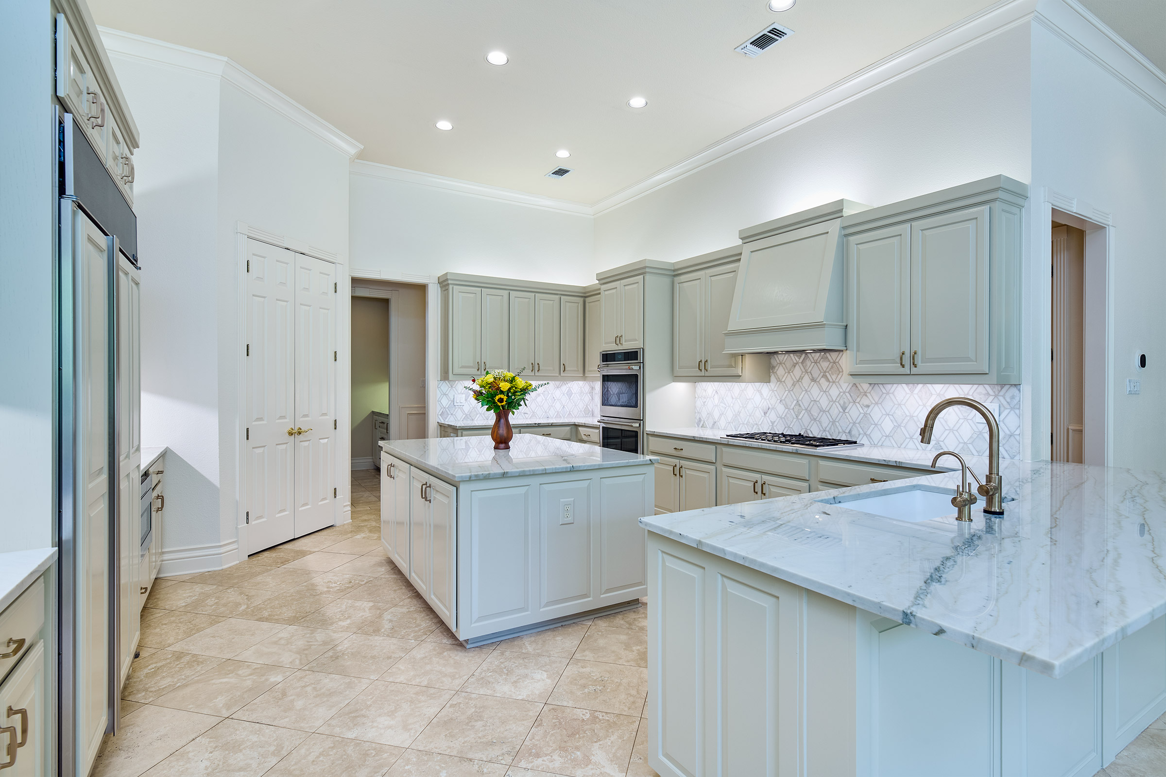 Sage green kitchen island and cabinets in a San Antonio kitchen remodel