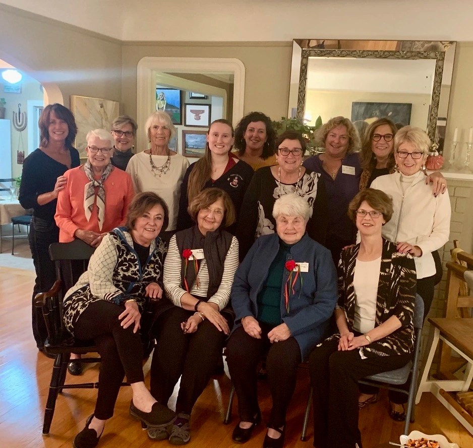 Lamda Lamda Alpha chi Omega alumnae gathered at a members home in the living room