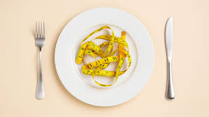 photo showing a plate with a tape measue on it to signify diet trends