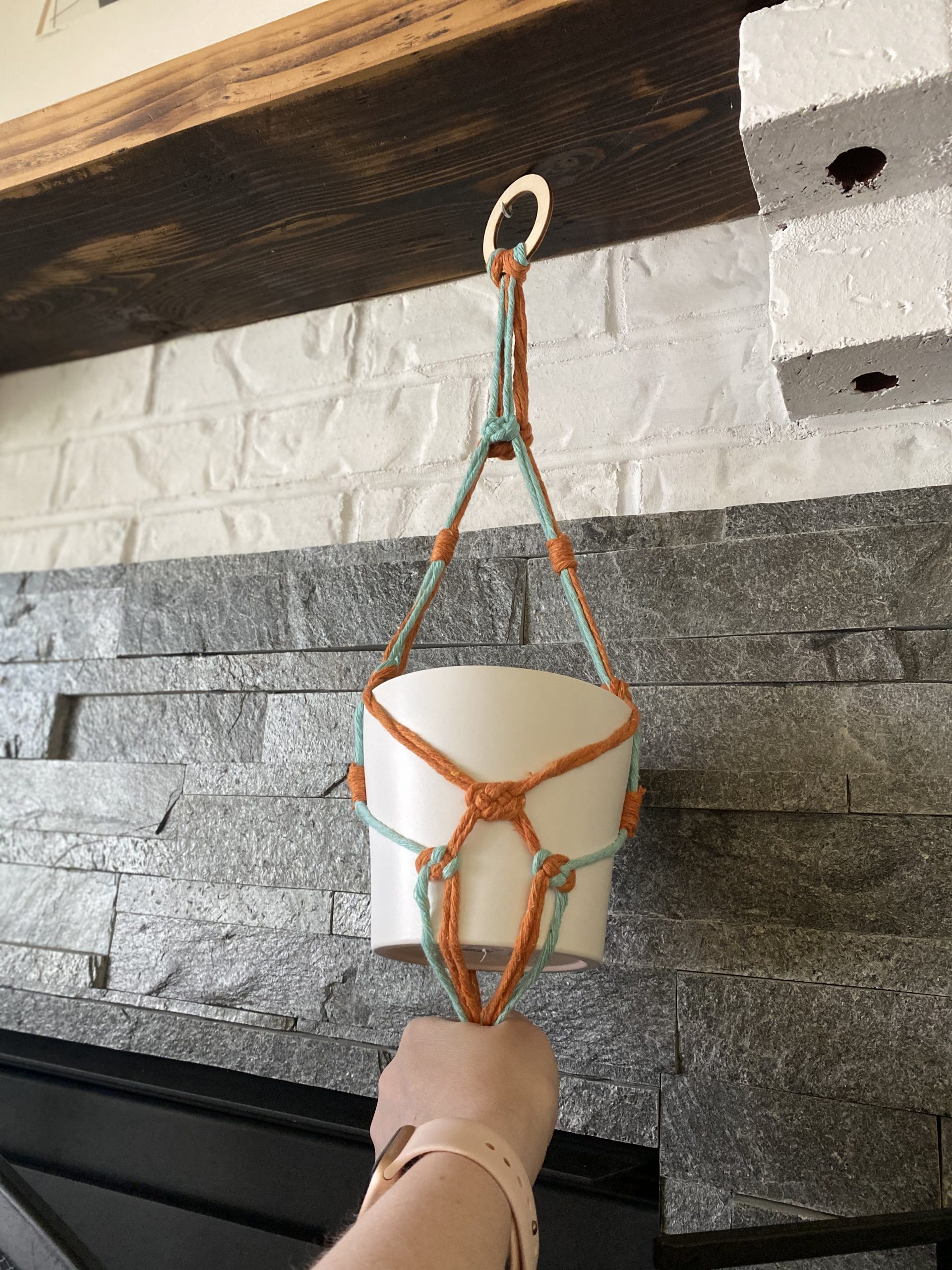 Adjusting placement of pot in the hanger.