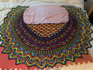 Sarah's shawl blocking and taking up most of a queen sized bed.