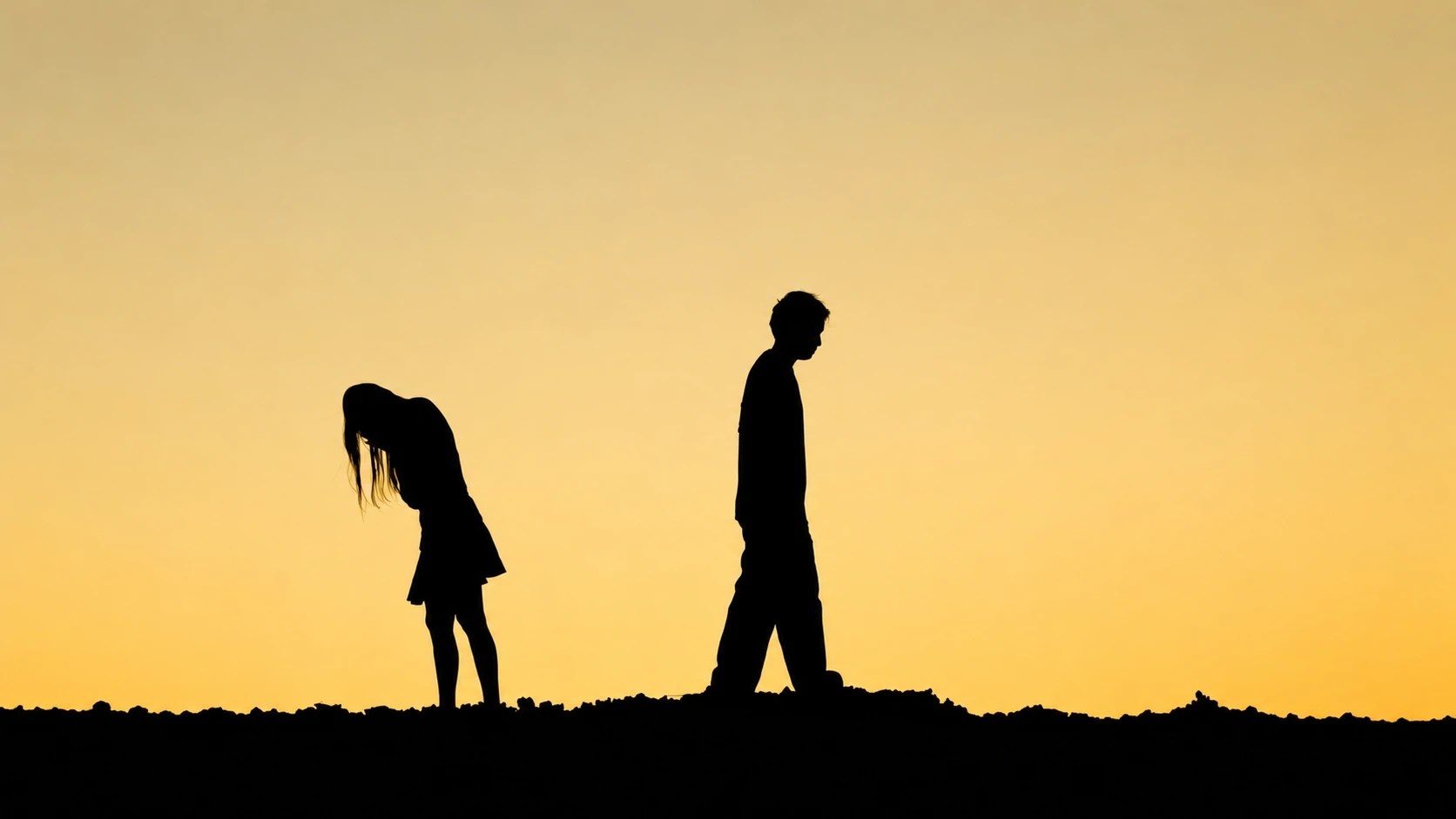 Silhouette of man walking away from a woman bent over crying