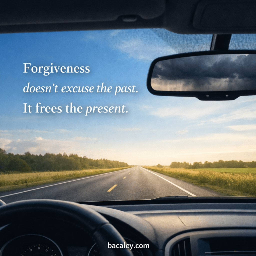 View looking out a car windshield towards an open road heading into sunshine. The rearview mirror shows a storm behind. Text says Forgiveness doesn't excuse the past. It frees the present.