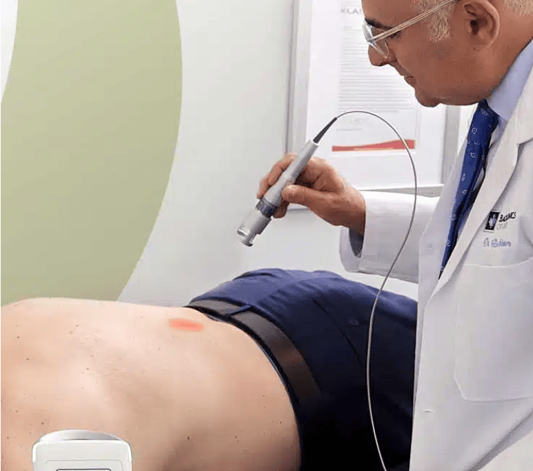 Class IV Summus laser therapy applied to a patient's spine