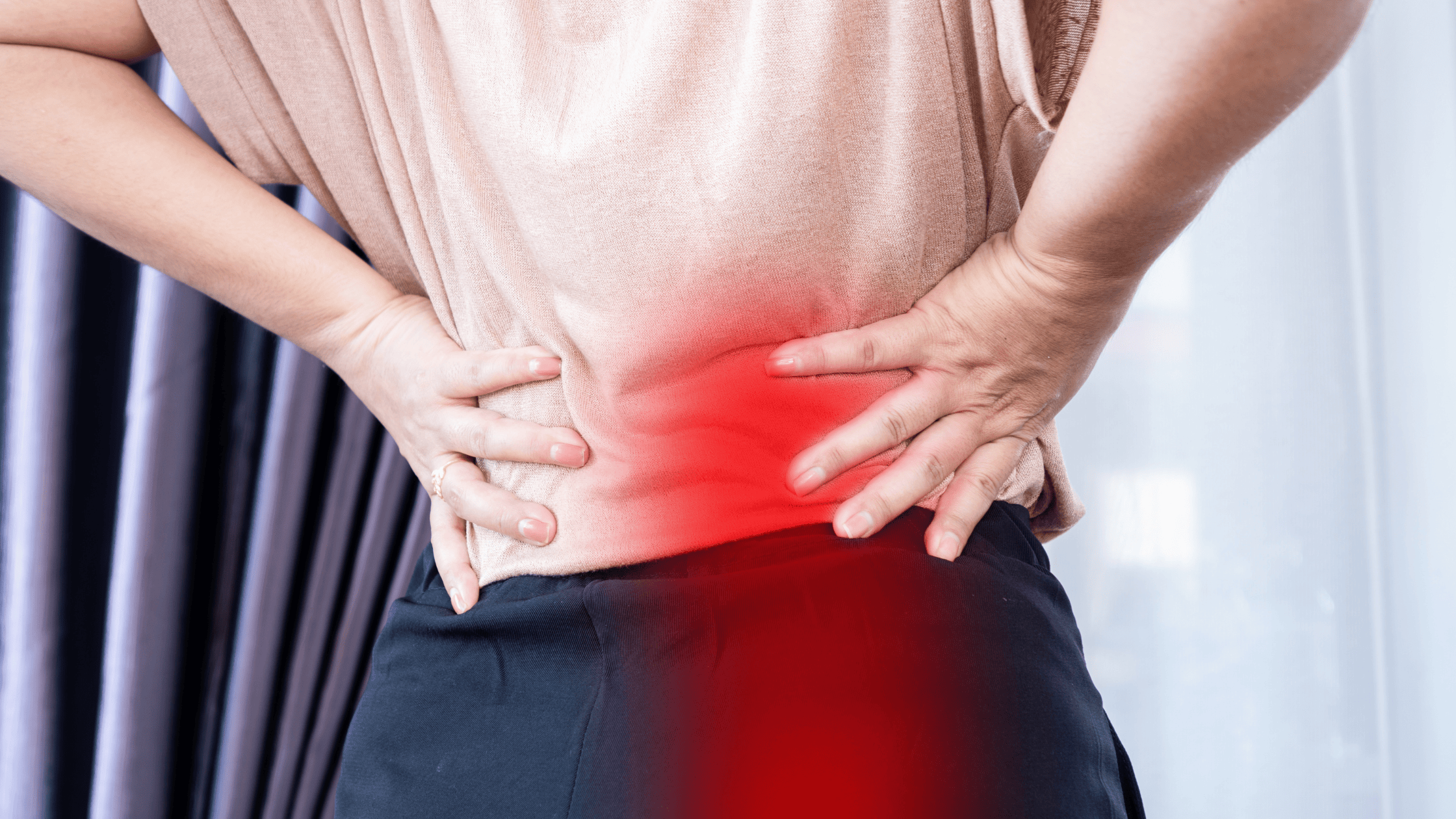 Person holding lower back and hip from sciatica pain