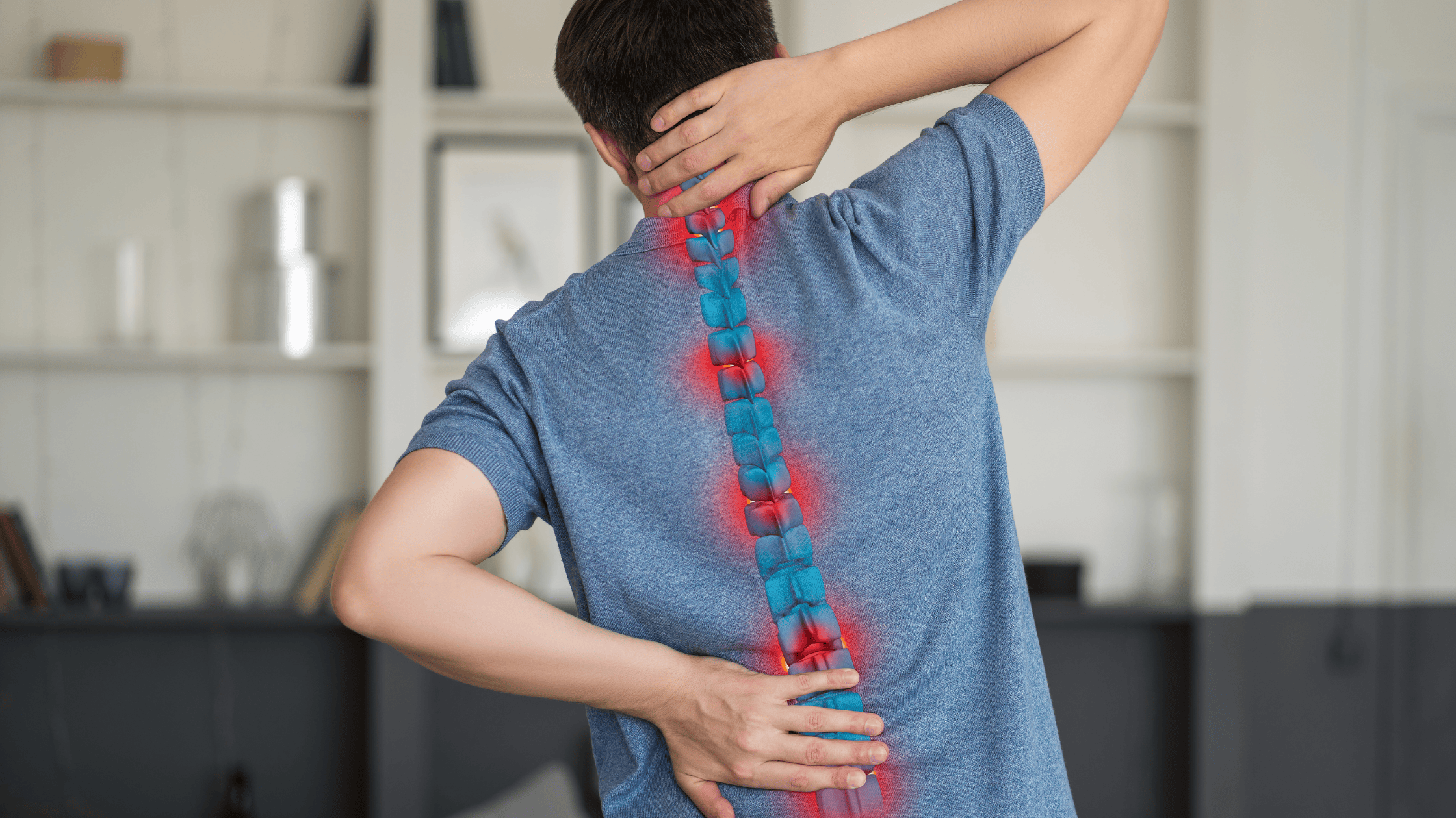 Person holding lower back from facet syndrome pain