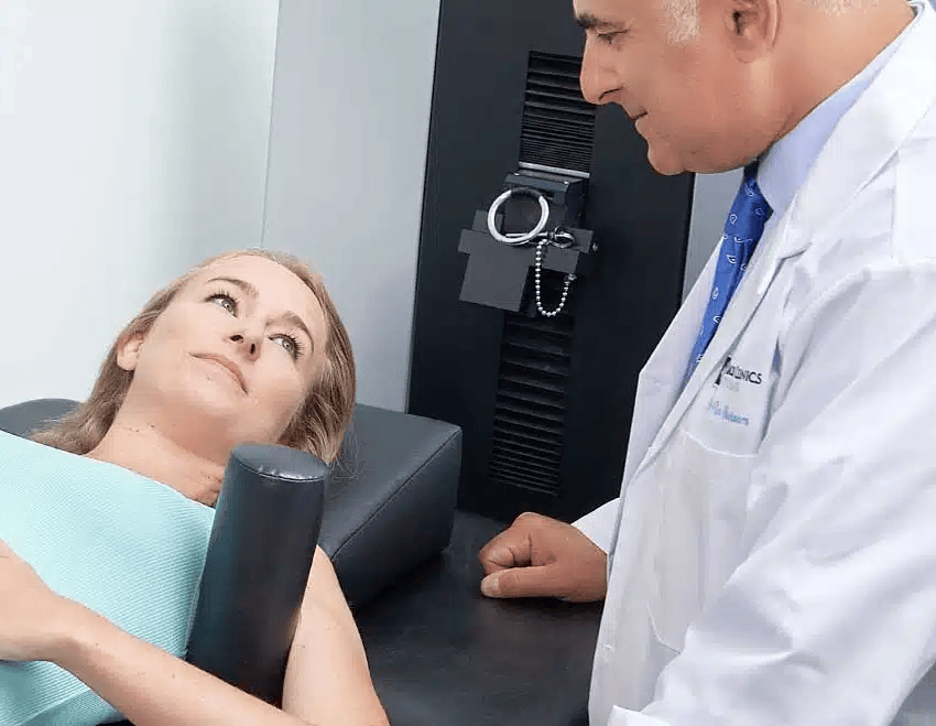 Dr. Ron Nusbaum performing non-surgical spinal decompression on a patient