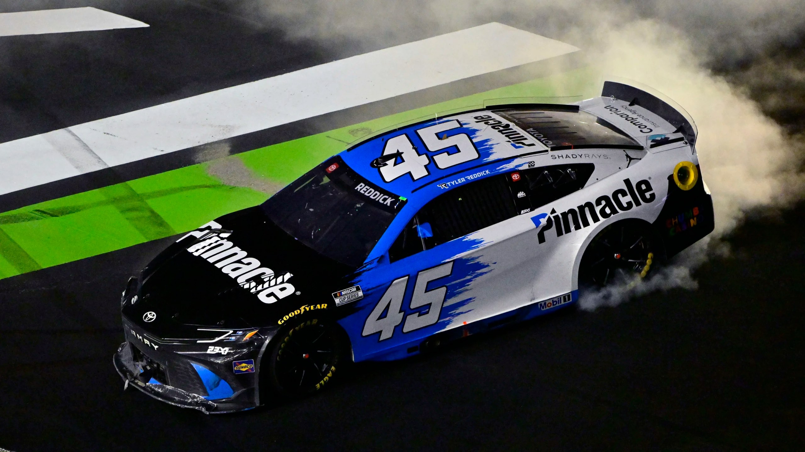 Tyler Reddick's No. 45 Pinnacle Toyota doing a smoky burnout in victory celebration