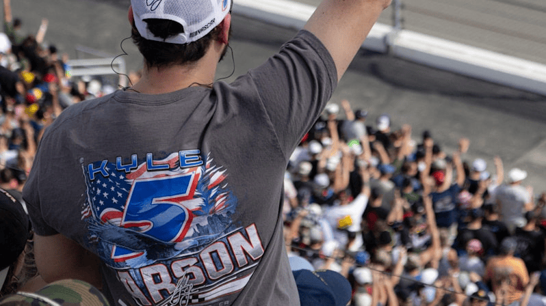 NASCAR fan wearing a Kyle Larson No. 5 shirt cheering in the grandstands