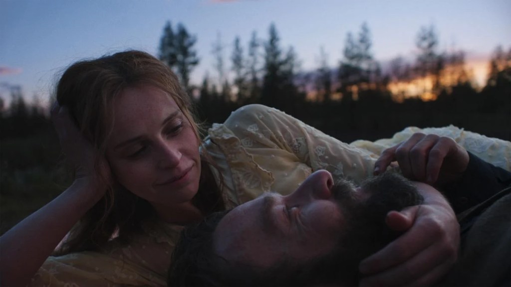 Joel Edgerton as Robert Grainier and Felicity Jones as Gladys Olding in an intimate moment.