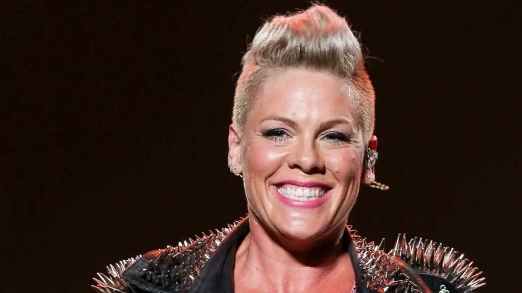 Pop star Pink smiling and wearing a spiked leather jacket while guest hosting The Kelly Clarkson Show in New York City.
