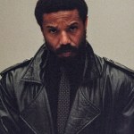 Michael B. Jordan wearing a dark leather jacket and tie in a first-look promotional photo for Miami Vice '85.