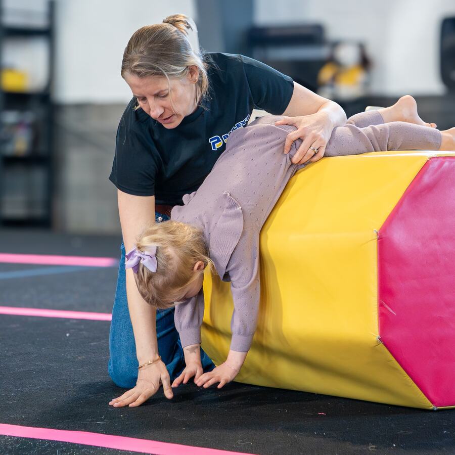 Mind and Motion preschool teacher guiding a young child