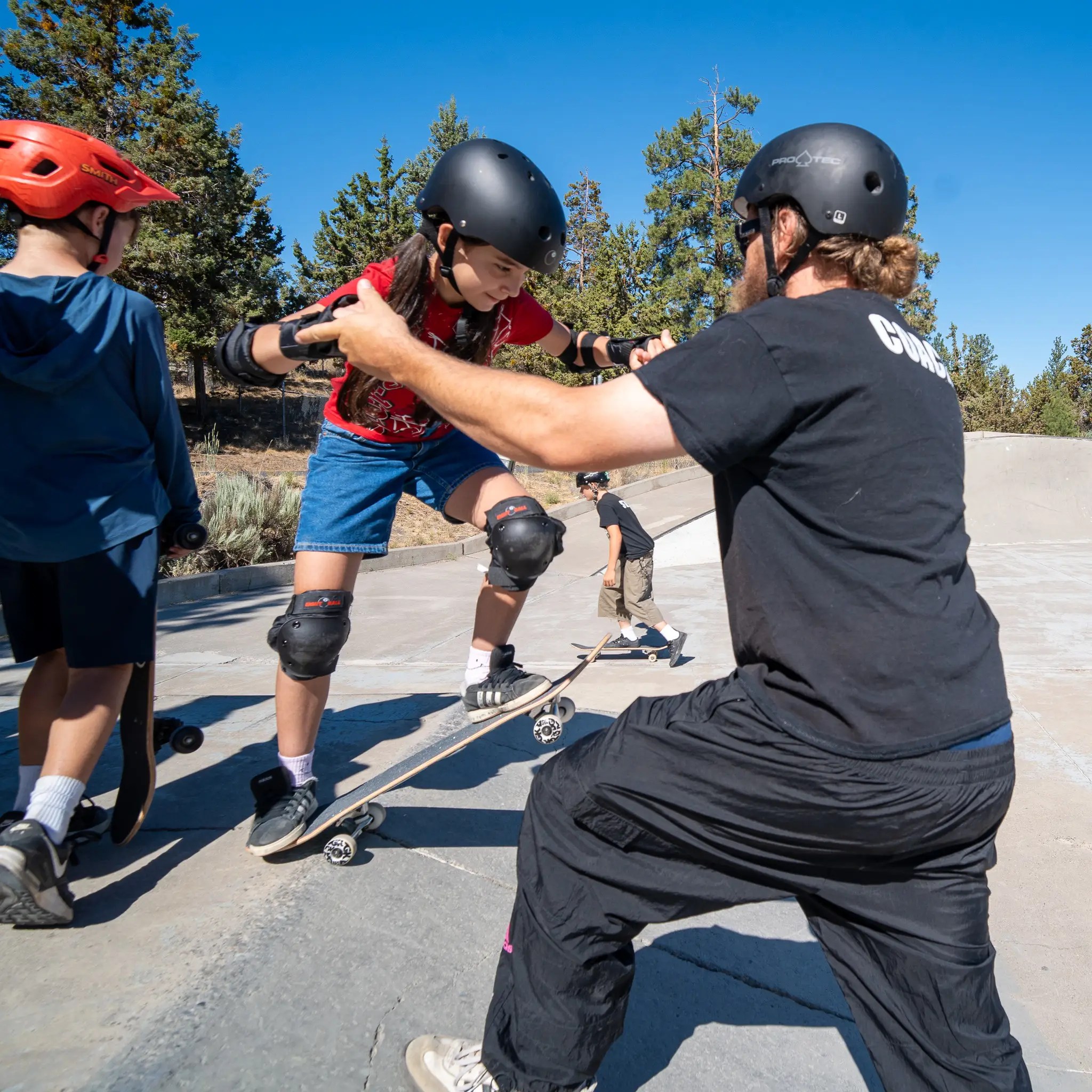 Skate camper practicing drop-in training at Ponderosa Skatepark