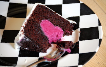 A bite of Chocolate Cake with a Raspberry Mousse Heart