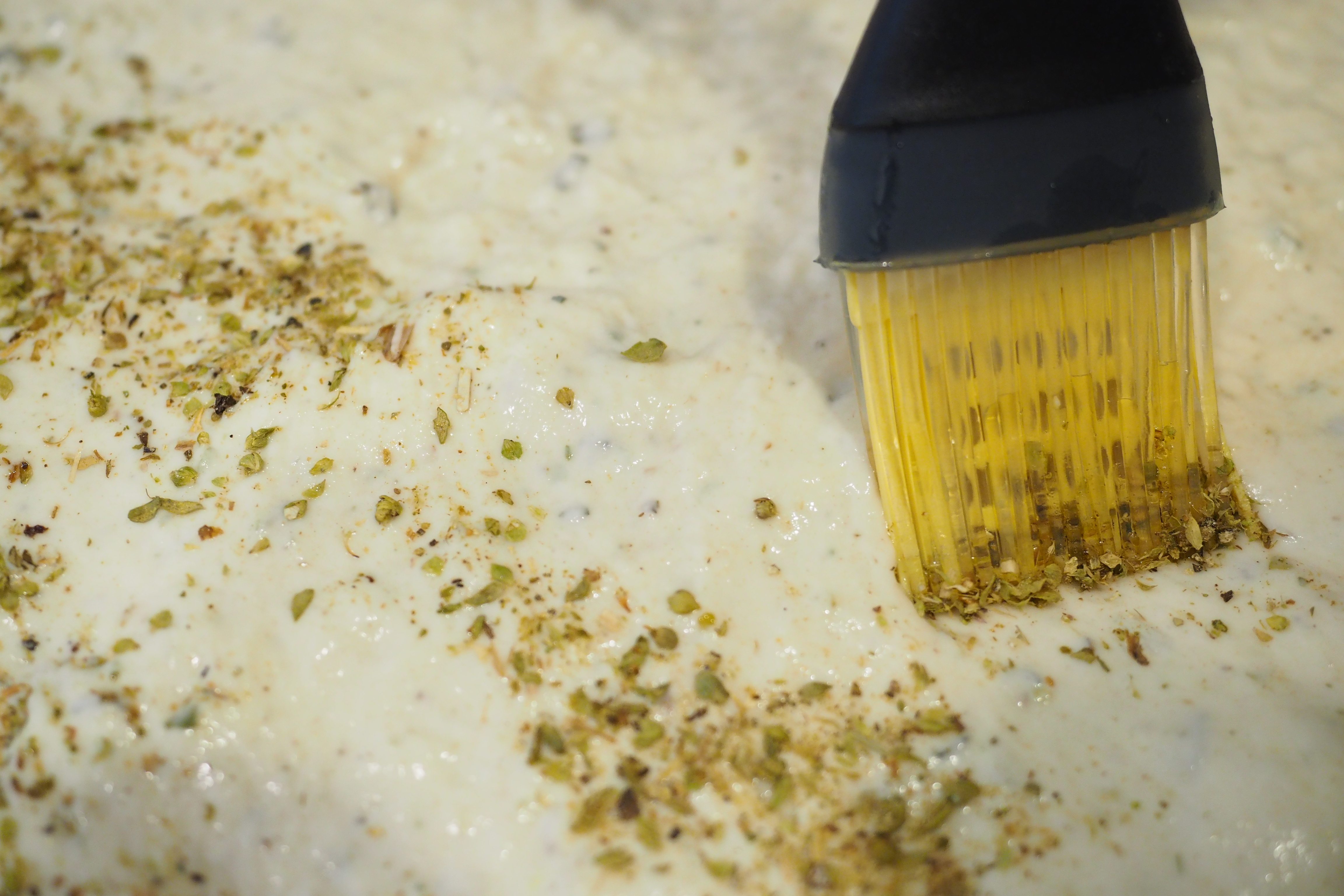 Seasoning the focaccia dough