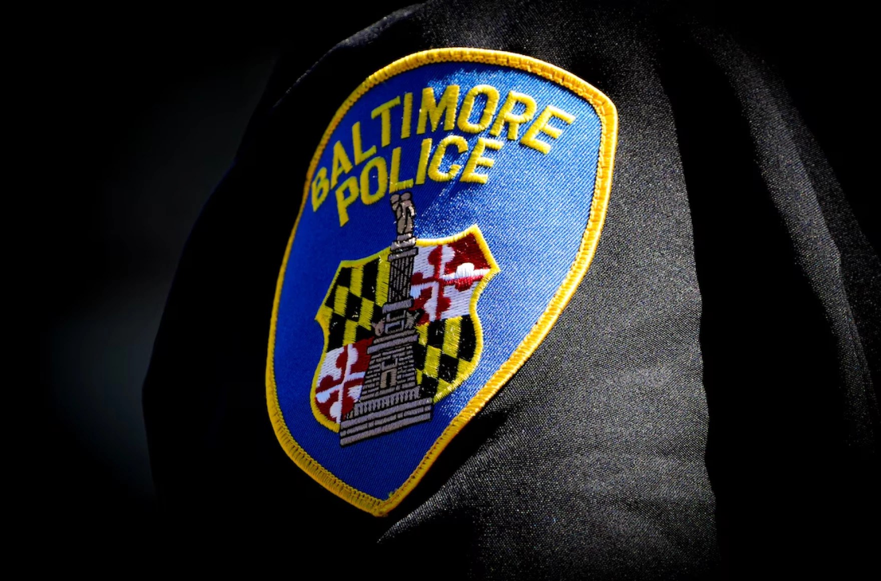 A Baltimore Police patch on an officer's uniform. Photo by Ulysses Muñoz / The Baltimore Banner.