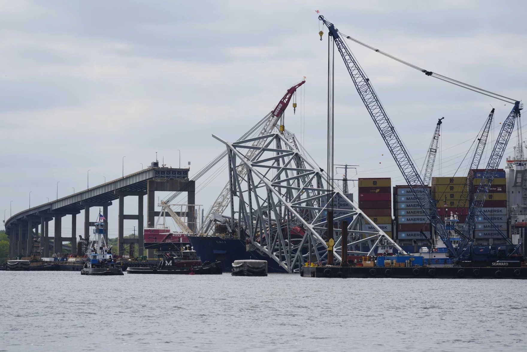 The collapsed Francis Scott Key Bridge lays on top of the container ship Dali, Thursday, April 25, 2024, in Baltimore. Photo credit: Matt Rourke / AP.