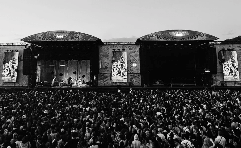 2 stages side by side with a huge crowd in front of them