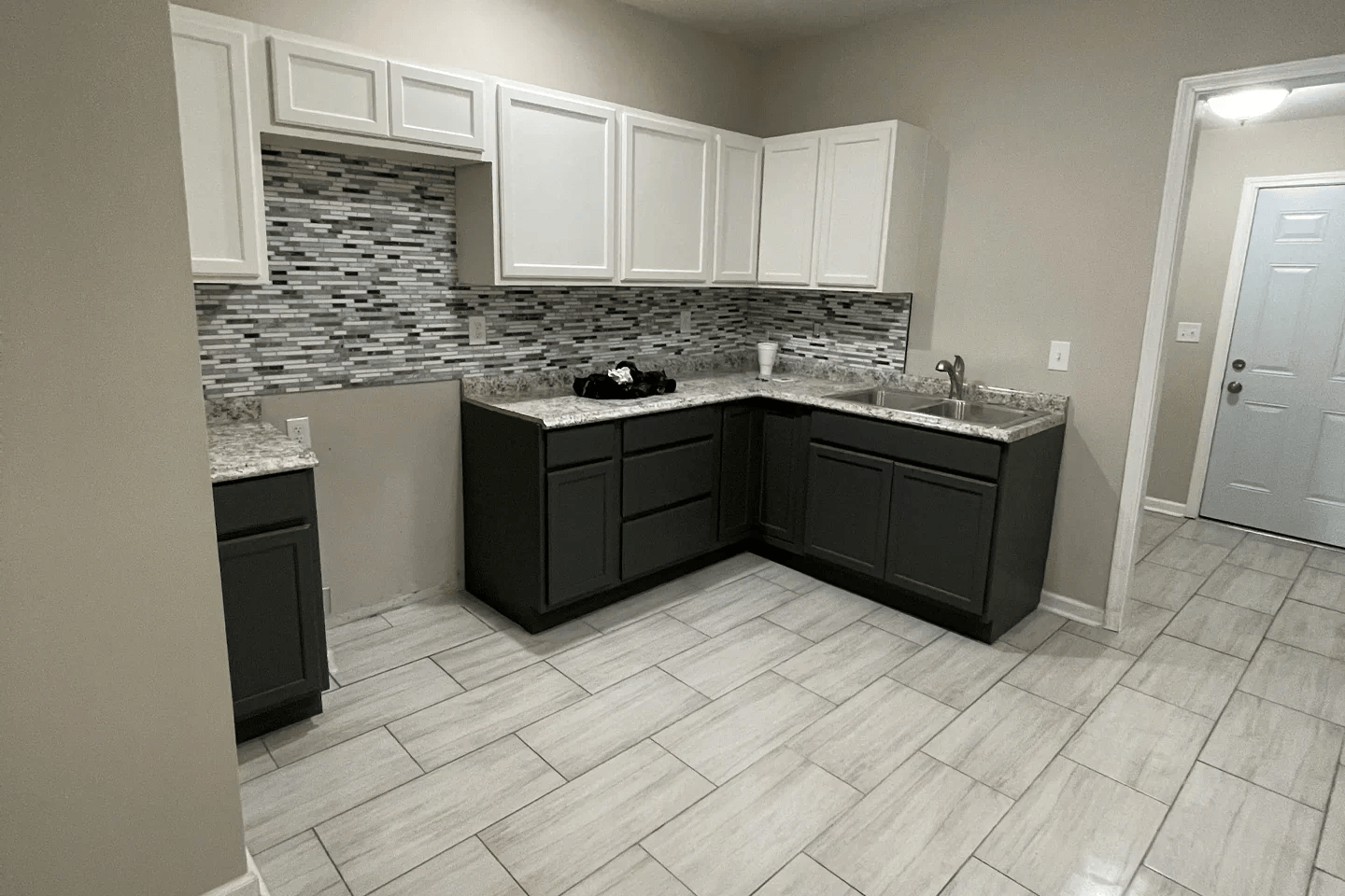 White kitchen cabinetry and dark countertops