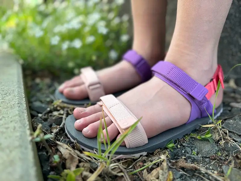 A pair of feet wearing Xero Shoes D-Trail sandals