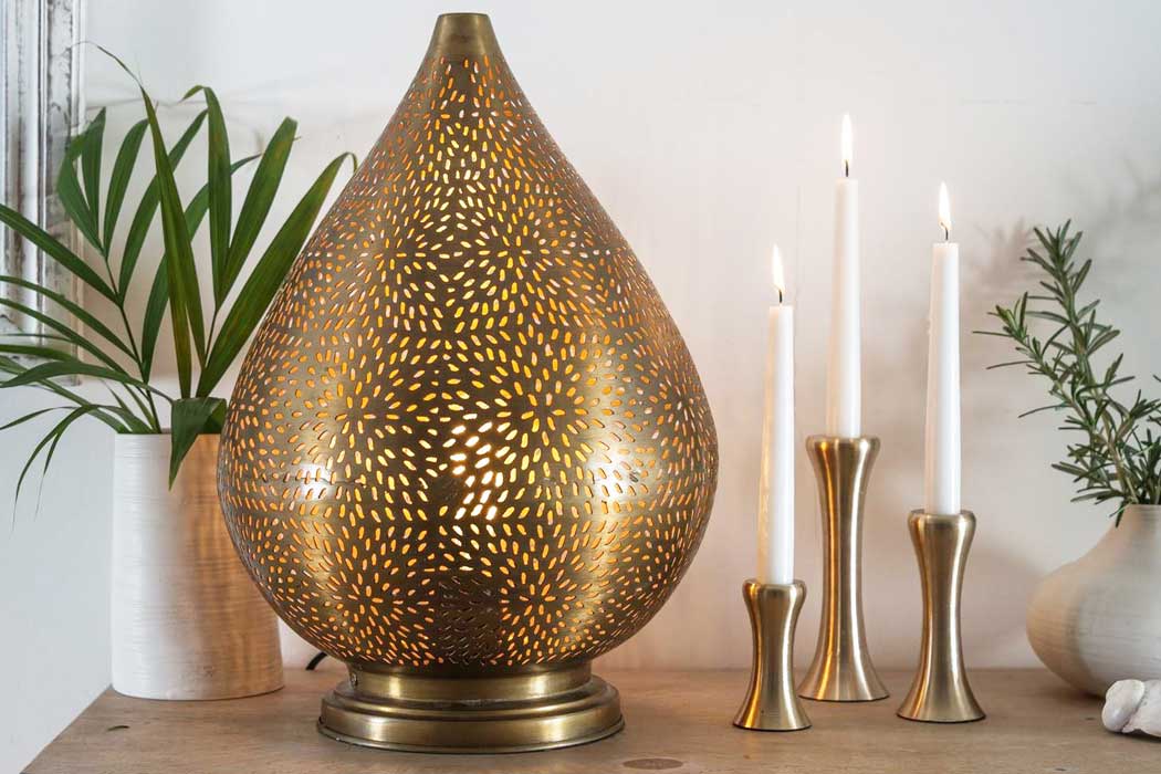 Medium Babloo table lamp with an etched metal shade and warm gold-coloured interior