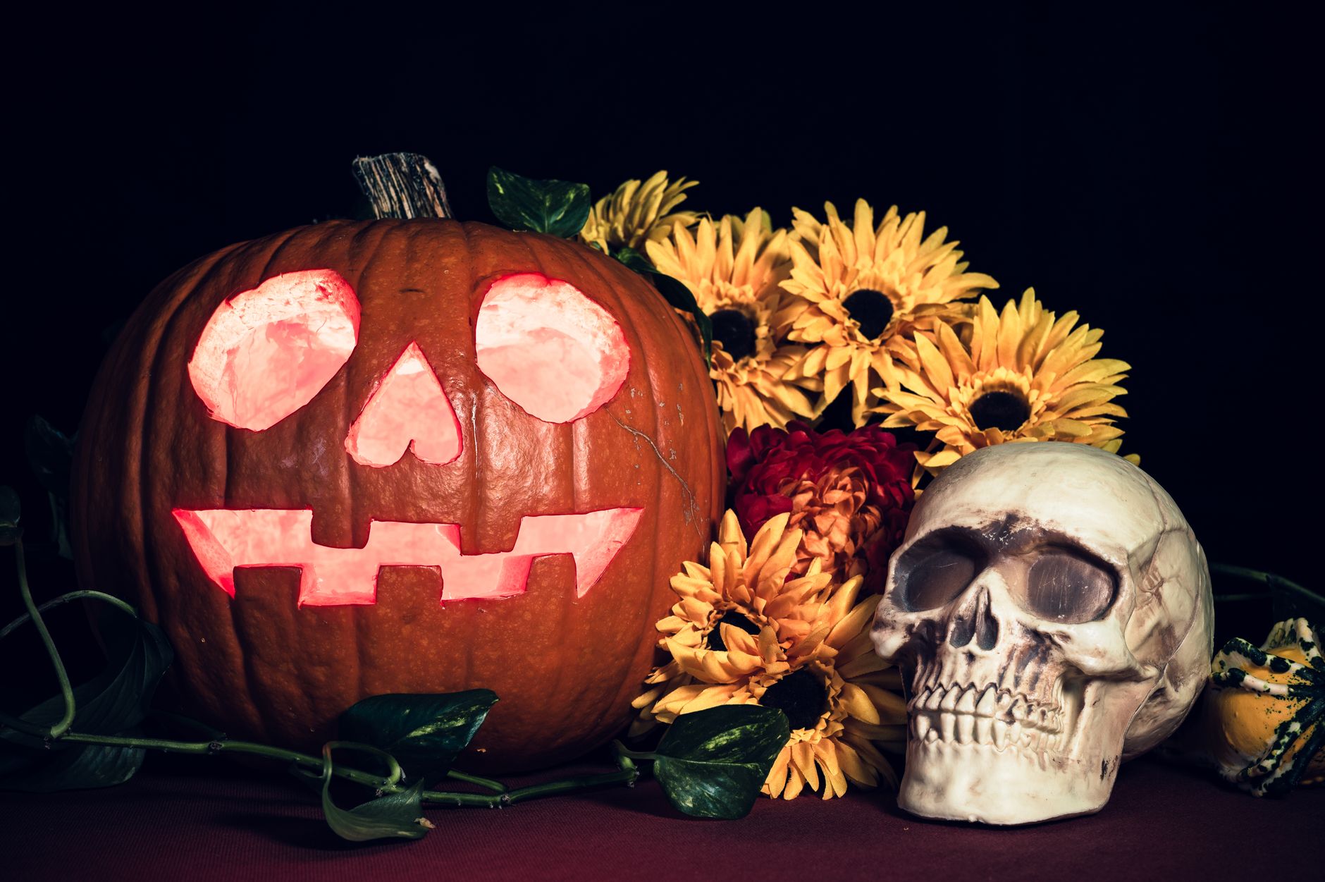 halloween jack o lantern with skull and flowers