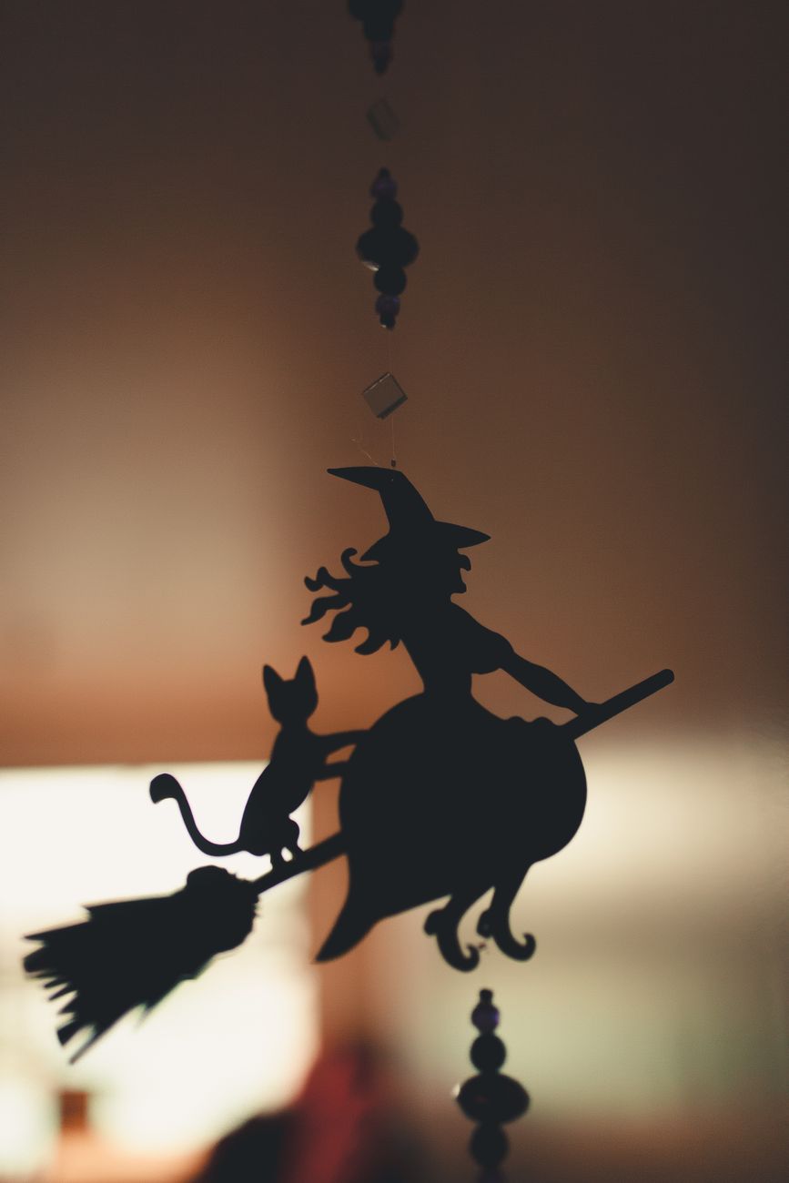 hanging decoration of witch and cat on broom