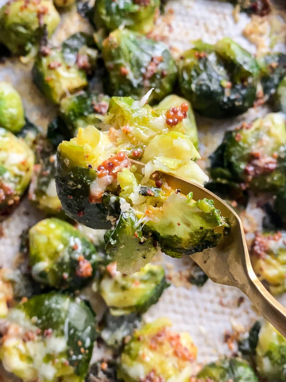 Close-up of a crispy charred smashed Brussels sprout on a fork