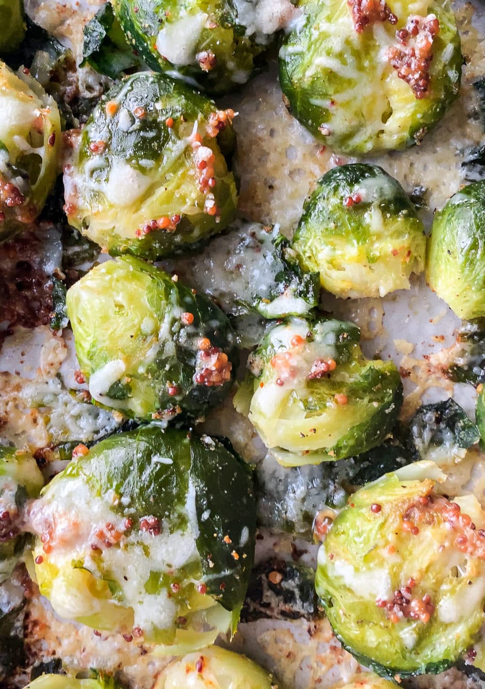 Top-down view of parmesan smashed Brussels sprouts with bacon bits