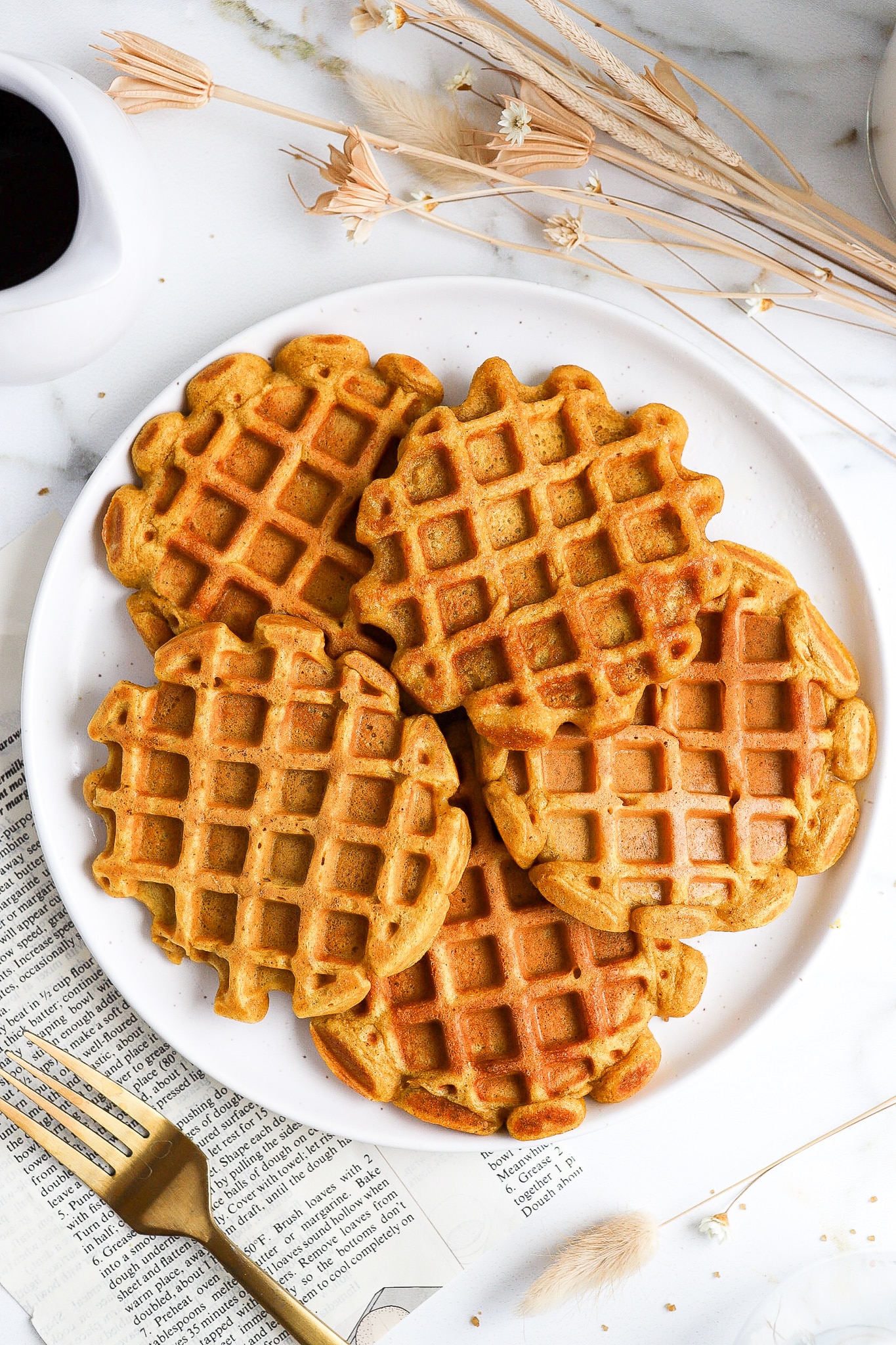 Mini pumpkin waffles made with pancake mix on a white plate