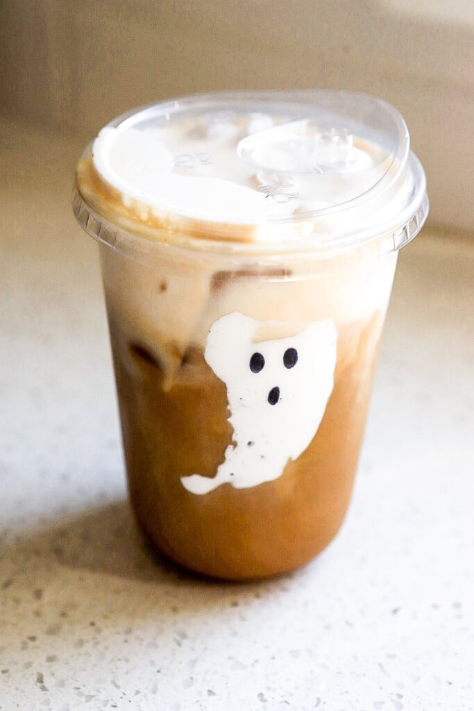 Fluffernutter iced latte in a tall glass topped with marshmallow cold foam