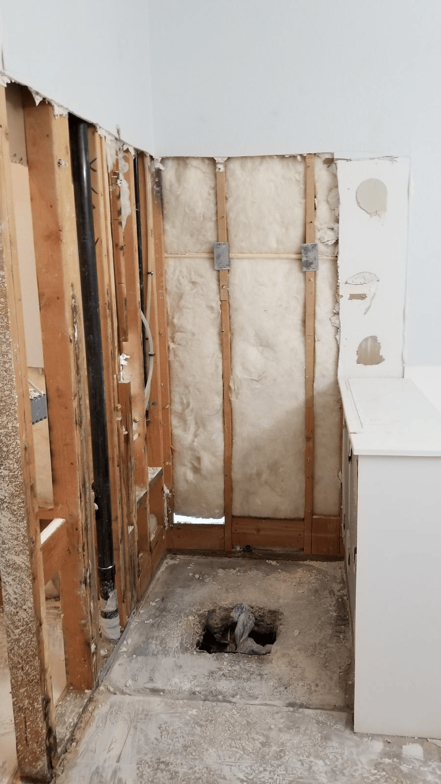 Henderson shower remodel before installation, showing exposed wall framing and plumbing